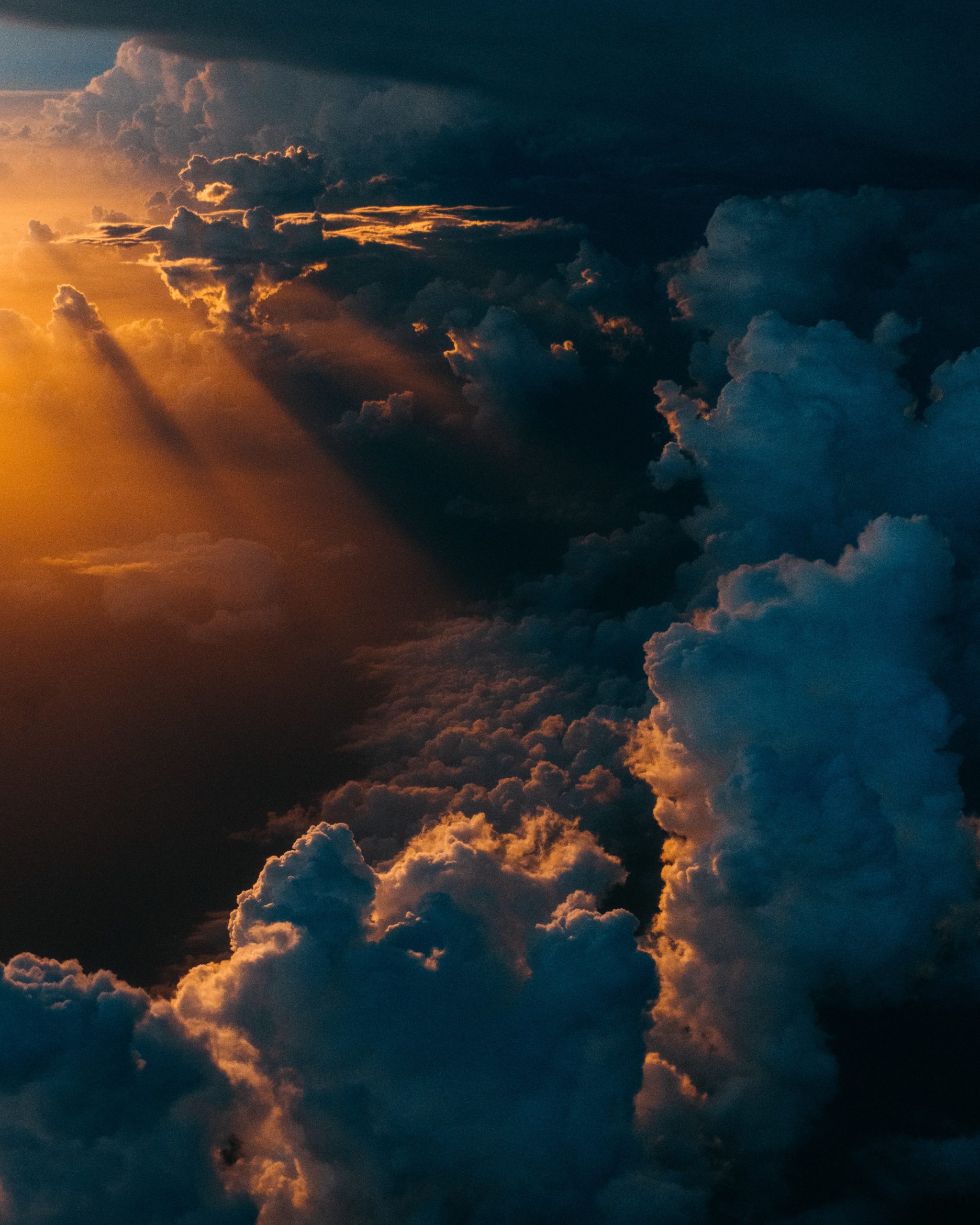 A picture of clouds and sunrays in the darkness | Spiritual Spatial Disorientation, a blog post by sunoppositemoon
